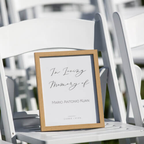 A white chair with picture frame "In loving memory of." How to celebrate your wedding when you've lost a loved one.