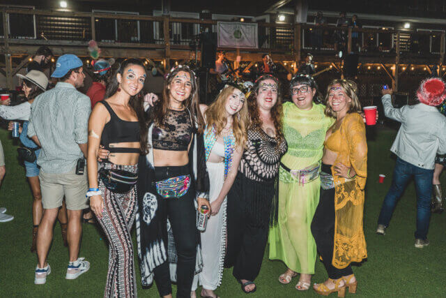 A group of women dressed in costume at an outdoor party