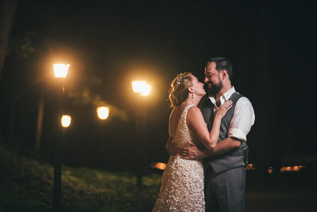 Bride and groom by streetlights 