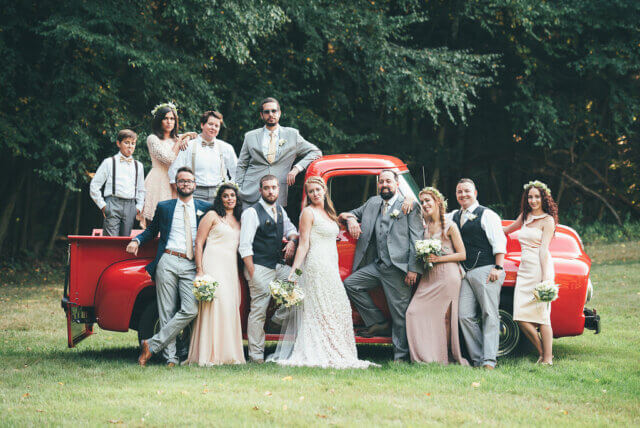 Bridal party gathered by red truck