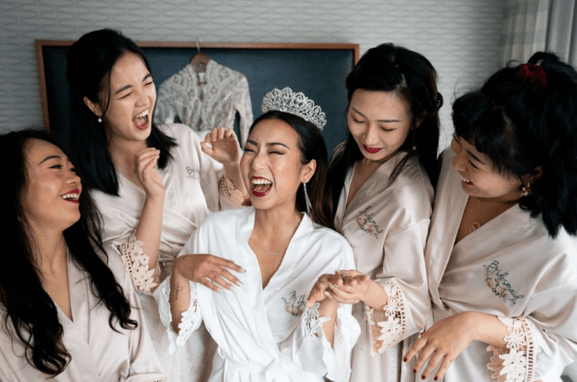 Bridesmaids surrounding a bride