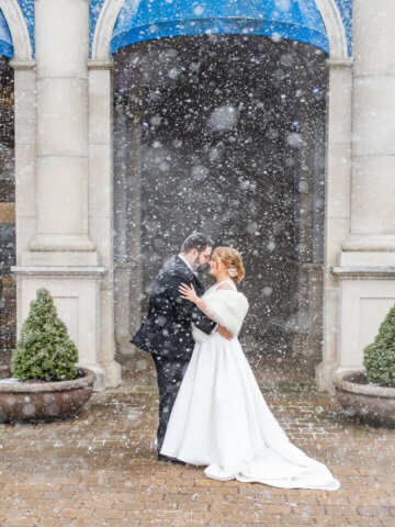 Couple in the snow outside Atlantis Banquets & Events.
