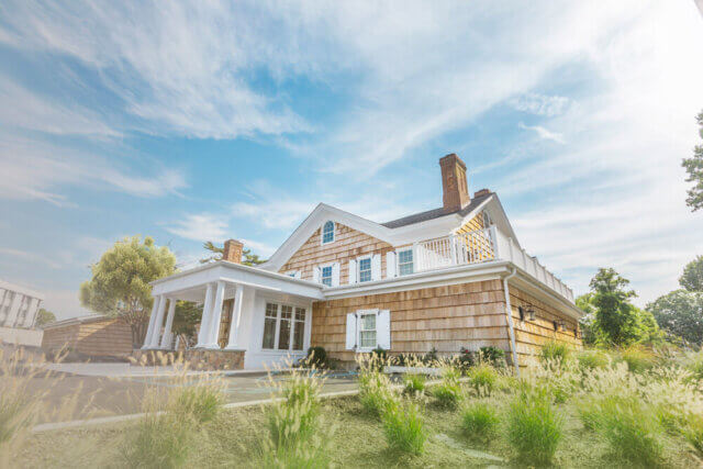 a house with a porch and a lawn