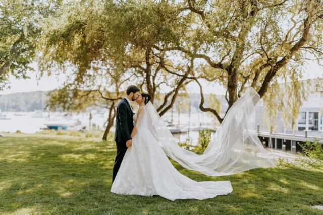 bride and groom kissing in a field