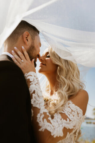 A bride and groom under her veil