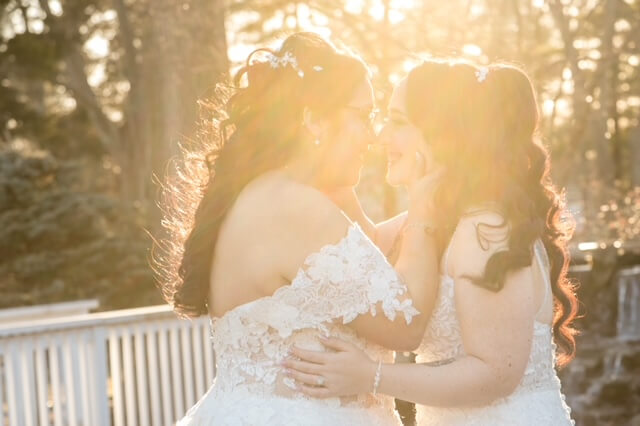 Two brides smiling on their wedding day