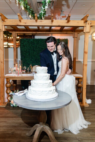 A bride and groom cutting a cake