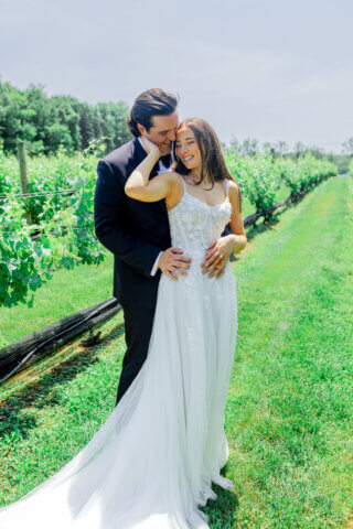 A bride and groom standing in a field