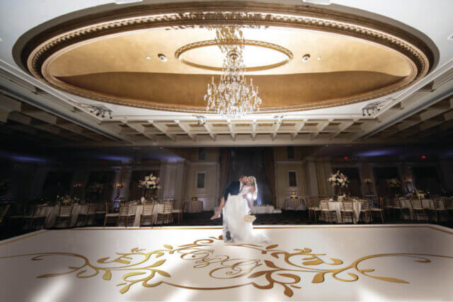 A couple kissing on an empty dance floor