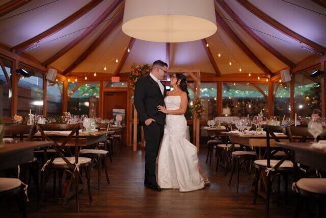 A bride and groom looking at each other in a dining room