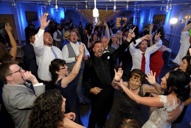A crowded dance floor at a wedding