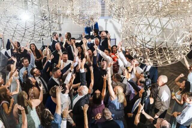a crowded dance floor at a wedding