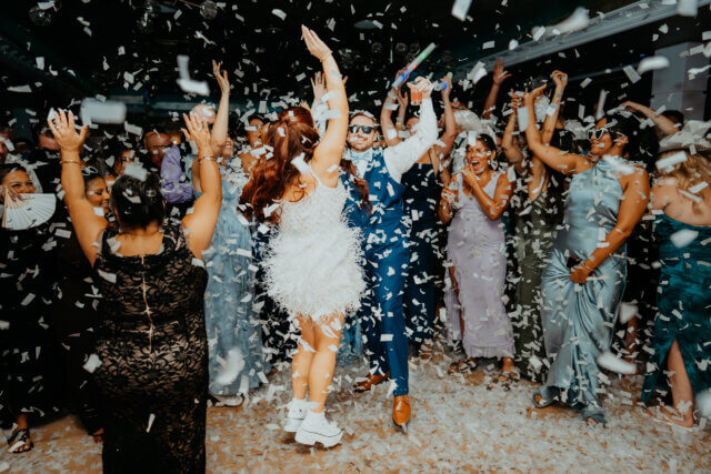 Bride and groom on the dance floor surrounded by confetti