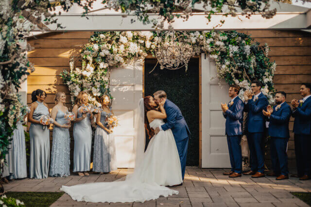 Bride and groom kissing at the altar