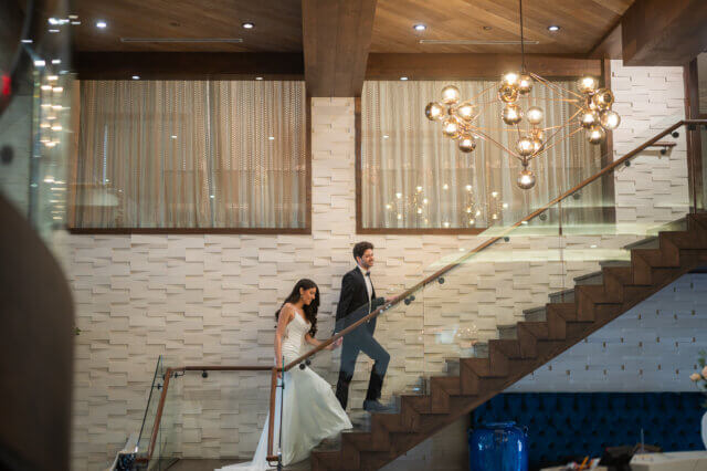 Bride and groom climbing stairs