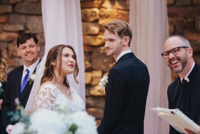 A couple saying their vows at the altar