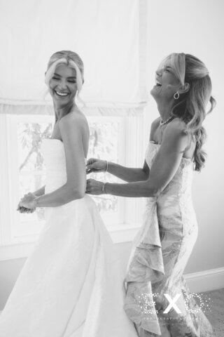 A mother and daughter laughing at a wedding