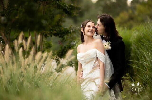 A bride and groom in a field